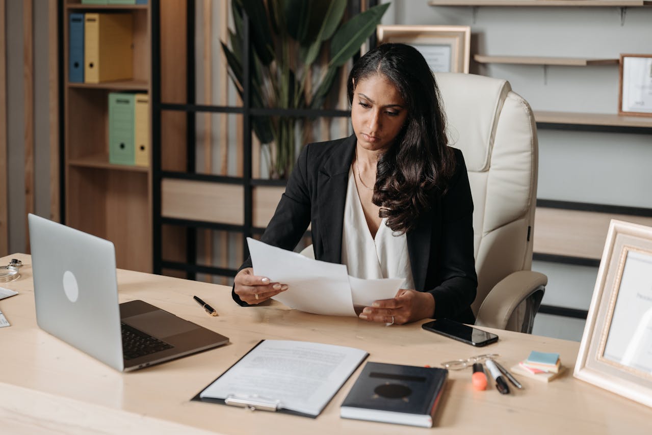 A woman in a business suit reviewing records