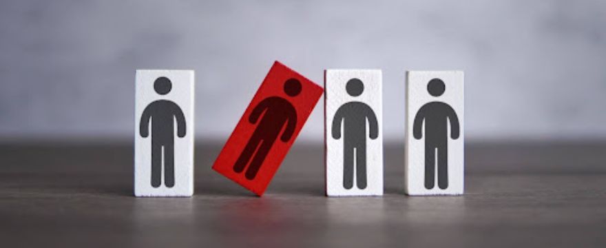 One red block with a human figure at odds with three surrounding white blocks