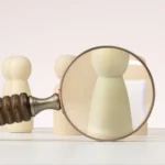 A figure is singled out for viewing with a magnifying glass