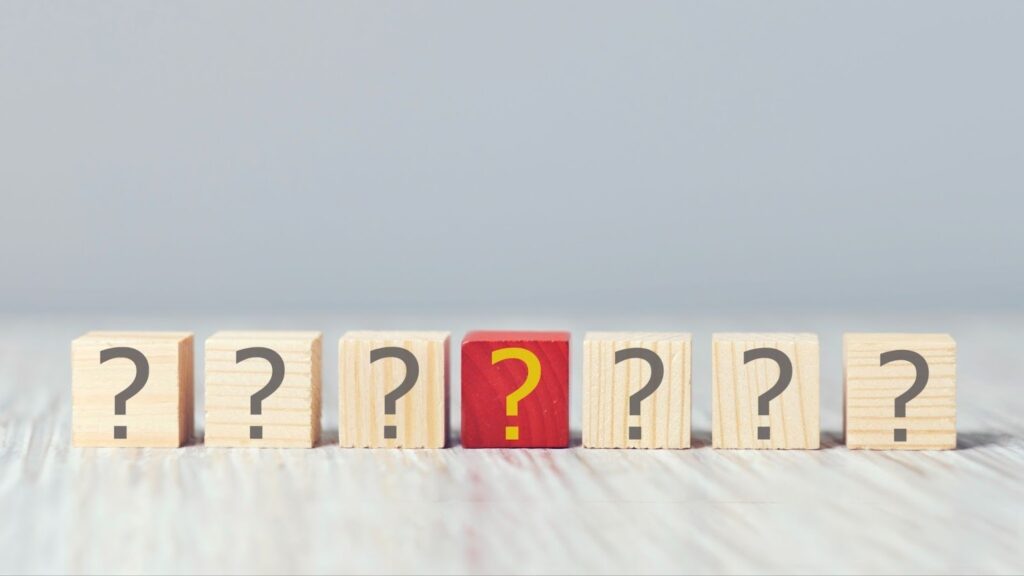 A red question mark block stands in the center of plain question marks